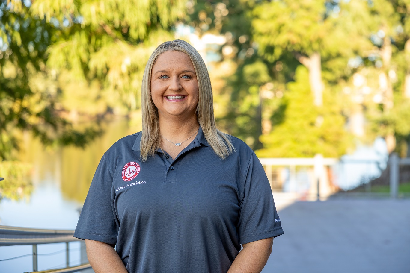 Portrait of Courtnie Beach, ULM Alumni Association Board Member, standing on campus near the bayou.