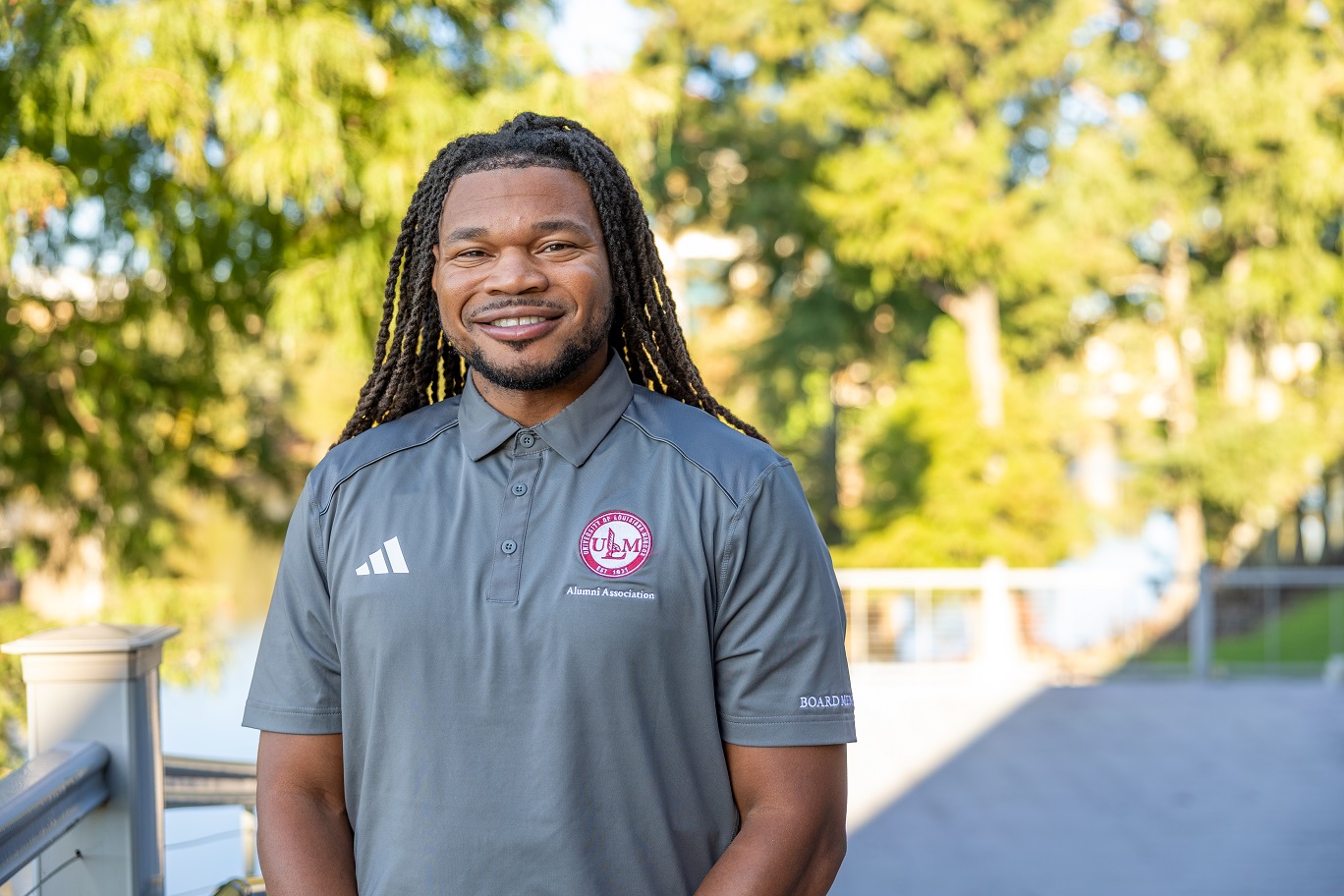 Portrait of Robert Brown, ULM Alumni Association Board Member, standing on campus near the bayou.image