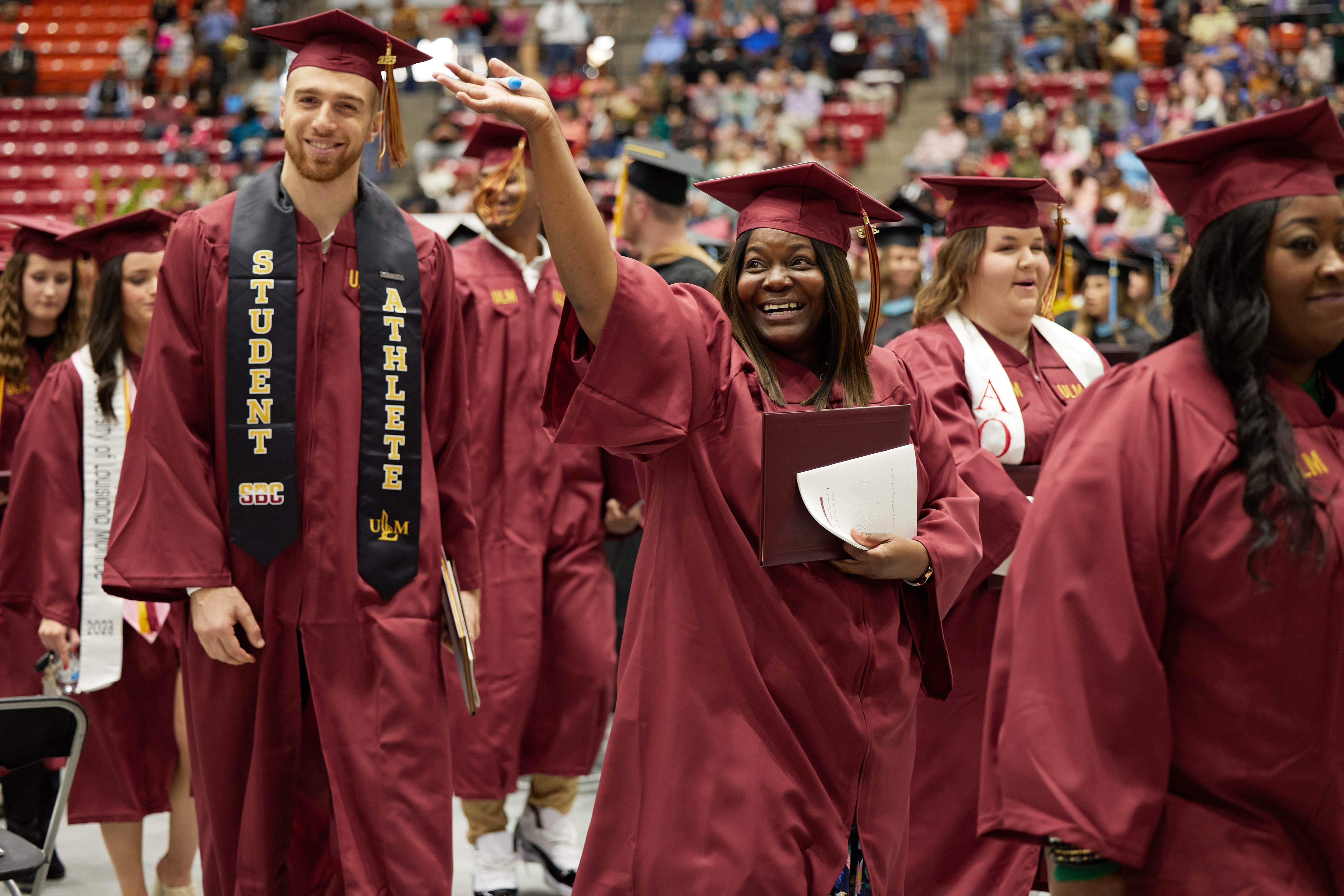 Commencement Recessional Students at commencement leaving the ceremony for the recessional, celebrating and waving to friends and family