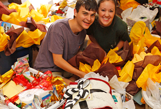 ULM students Bryson Belaire and Morgan May prepare care packages for the Ouachita Council on Aging. Photo of students